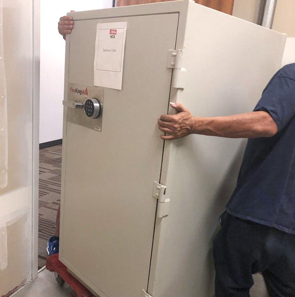 Mover and Installer removing a vault from an office