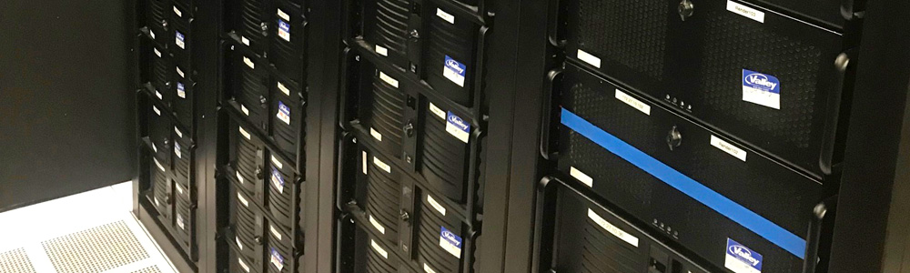 Large servers stacked side by side in an office space. 