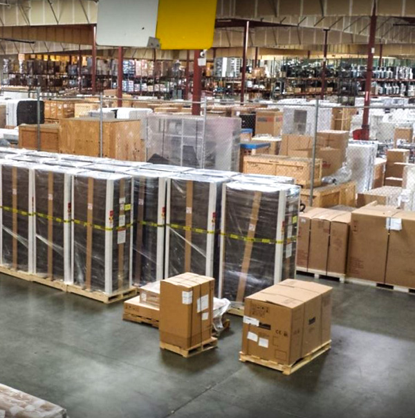 A large warehouse storage space with several boxes inside. 