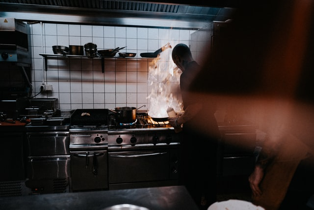 A chef cooking food in a restaurant.