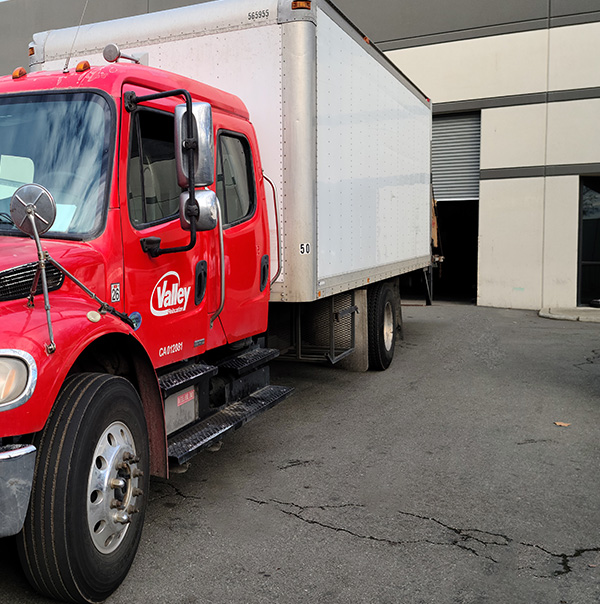 A Valley Relocation truck being used to transfer kitchen equipment.