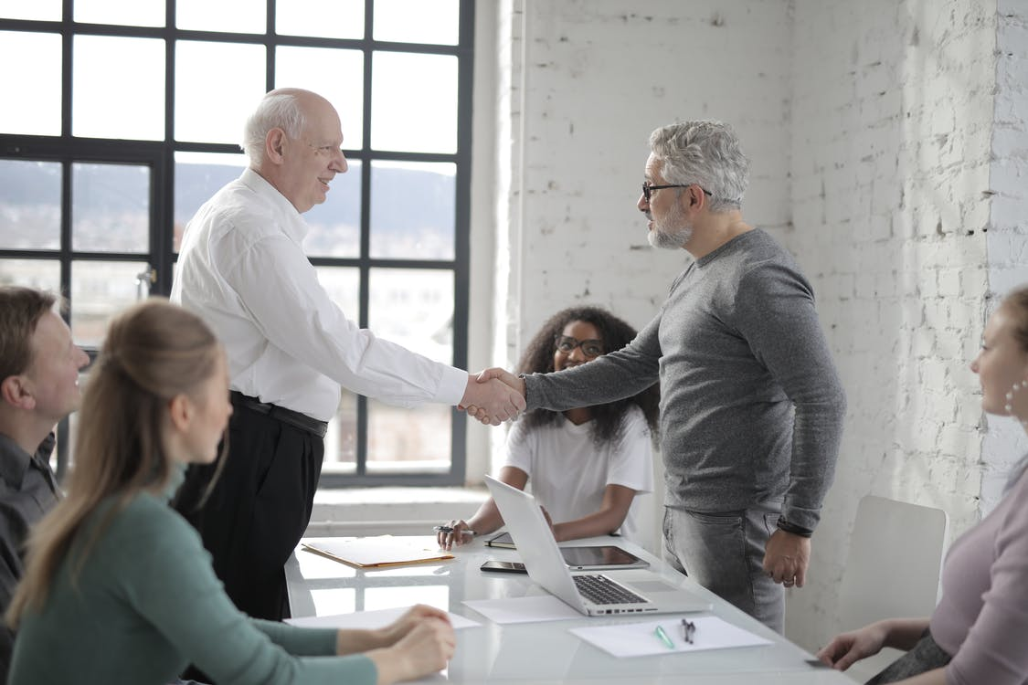 Two men shaking hands at the office meeting