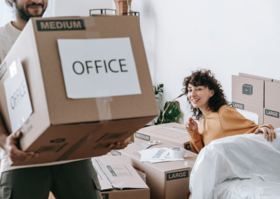 A man and a woman packing and moving boxes