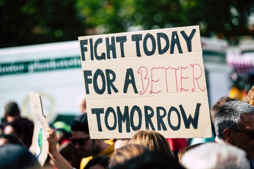 Someone holding a banner in a protest