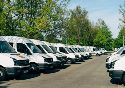 several vans parked on the road.