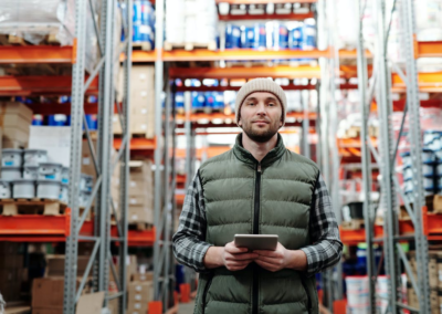 A warehouse manager holding a digital tablet