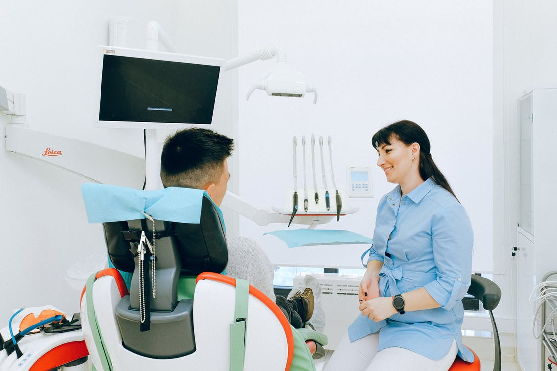 A dentist having a conversation with a patient
