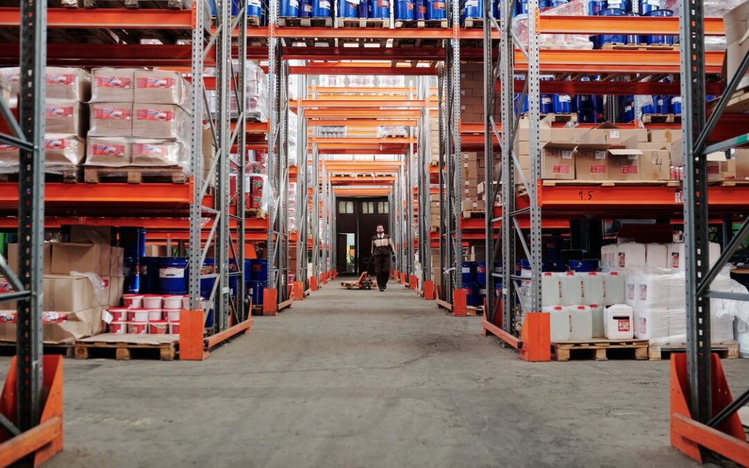 Worker walking between the racks in a commercial warehouse