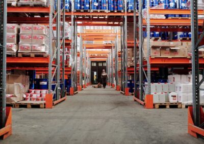 Worker walking between the racks in a commercial warehouse