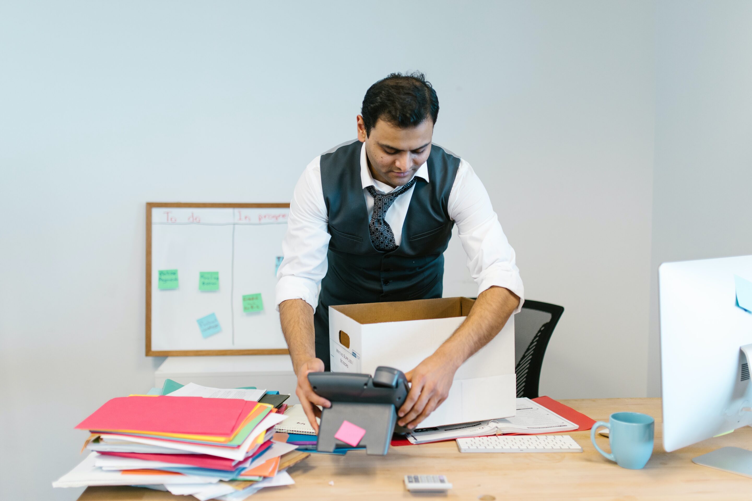 employee packing their thing before business office movers come