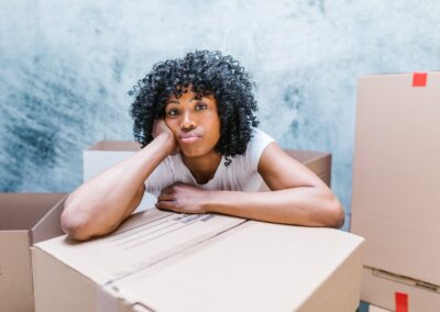 a woman packing boxes for heavy kitchen equipment moving