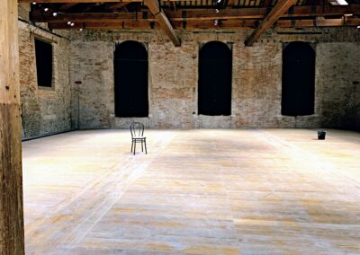 A Vacant Restaurant with Exposed Brickwork and Beams and Tall Windows Having Just Been Emptied by Commercial Moving Services