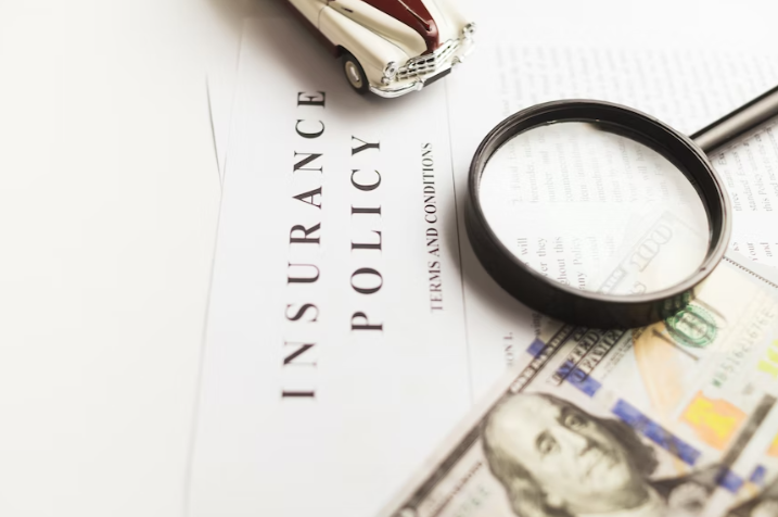 A magnifying glass placed on top of an insurance policy agreement. 
