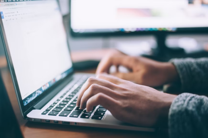 A person typing on their laptop. 