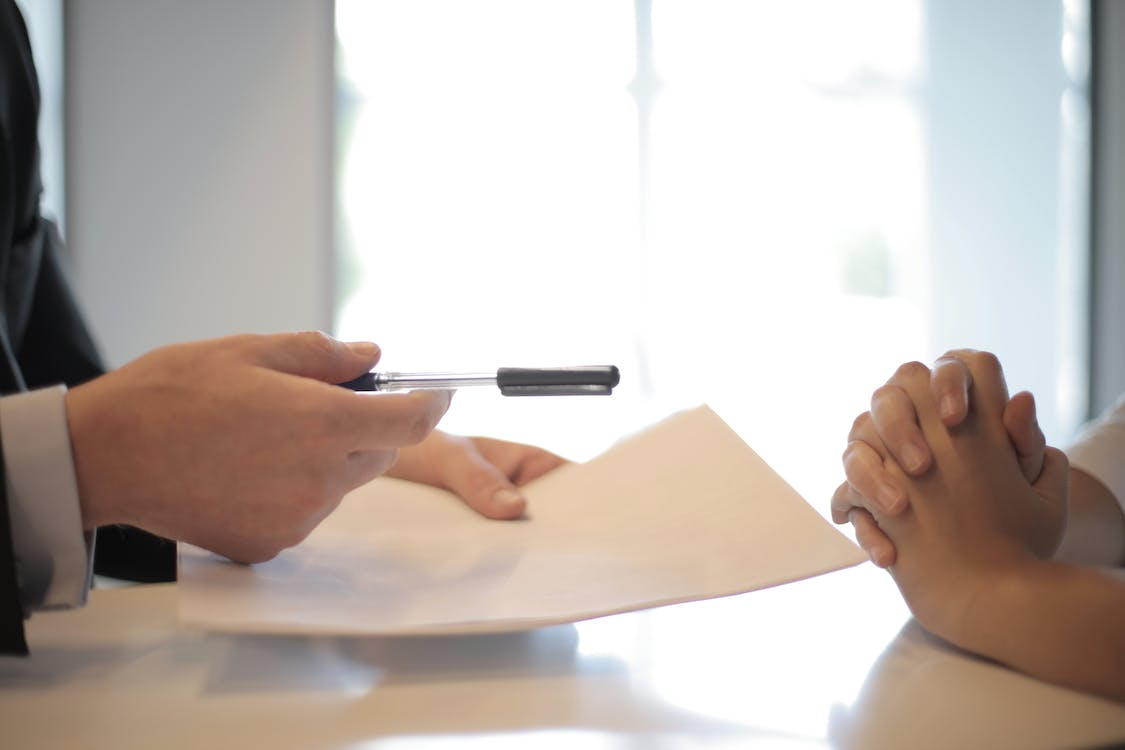 handing-pen-and-documents