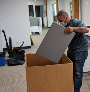 A man packing up different pieces of equipment. 