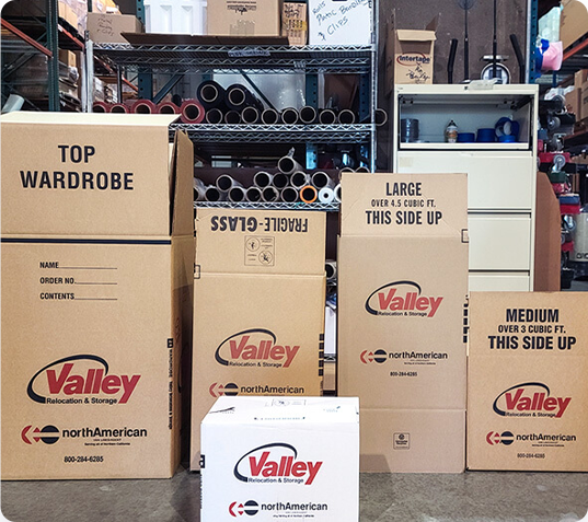 Several storage boxes laid out open in a warehouse. 