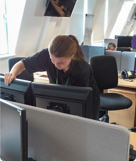 A worker unplugging equipment from an office relocation. 