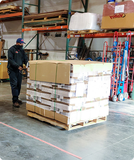 A large warehouse with a professional mover at work. 