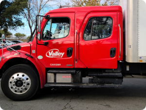 A large white and red truck for professional movers.