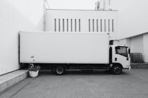 A white professional moving service truck parked in a space.