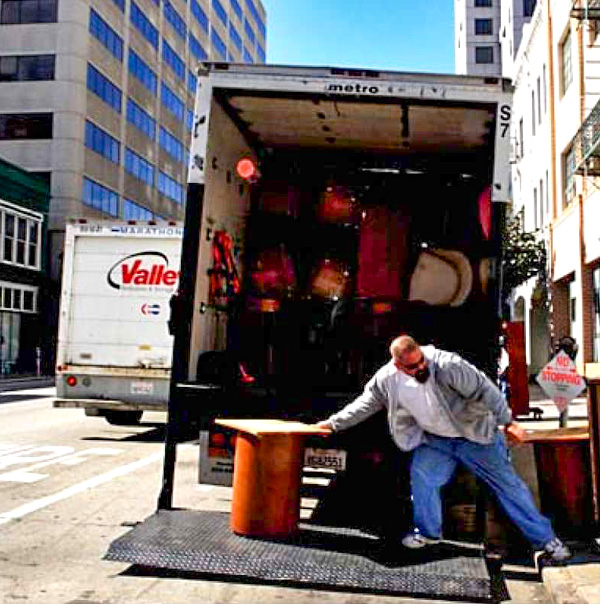 A person performing professional moving services outside.