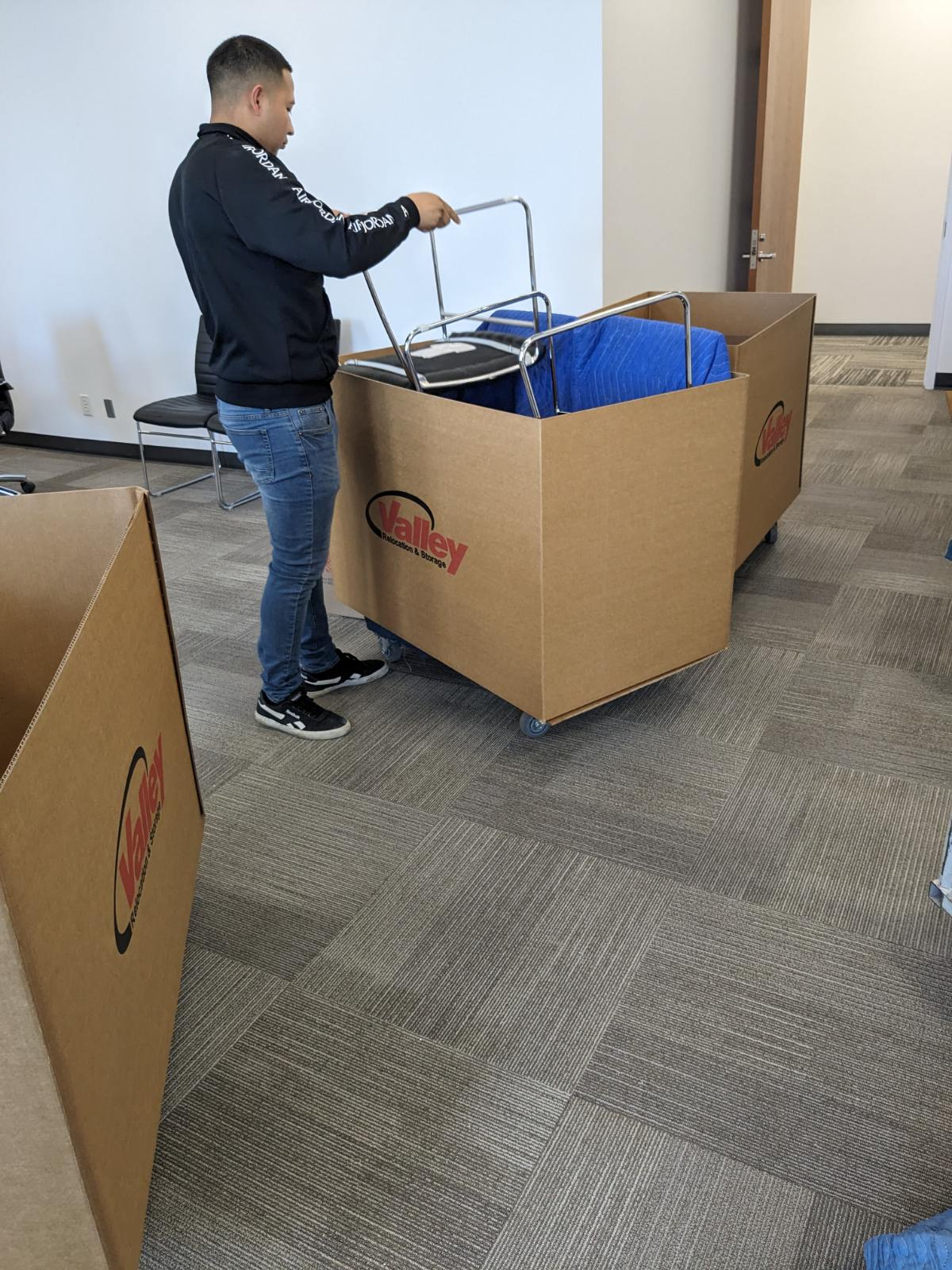 a person loading an item into a box.