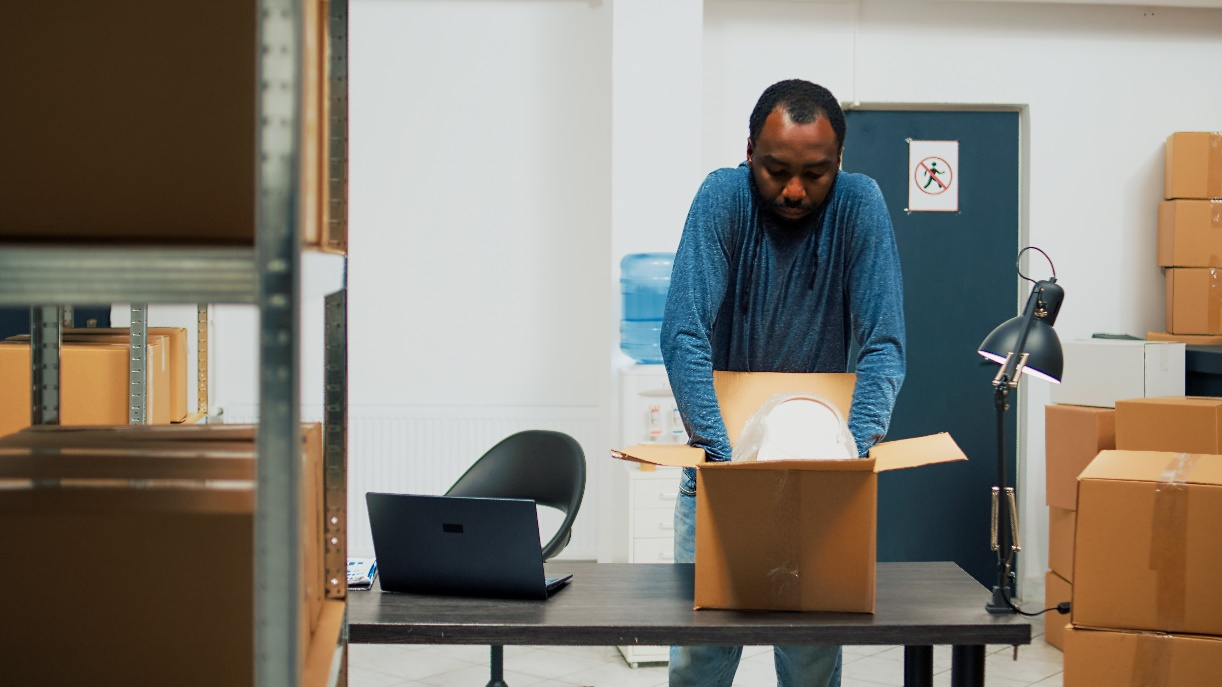 A person placing an item in a box.