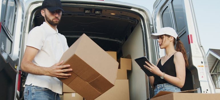 Movers unloading boxes and checking inventory.