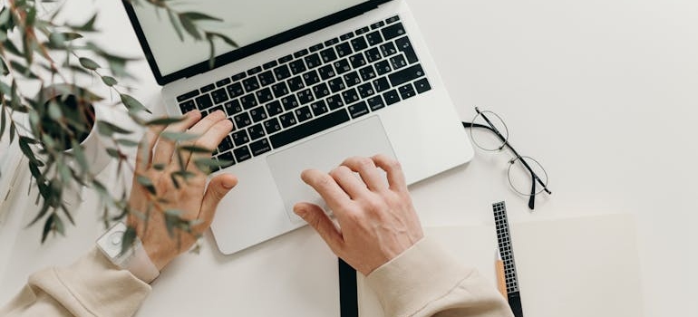 Woman typing on a laptop.