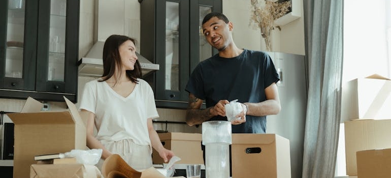 Couple unpacking their moving boxes as a symbol of how to safely relocate your household