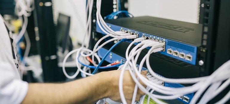 Man checking cables on a computer.