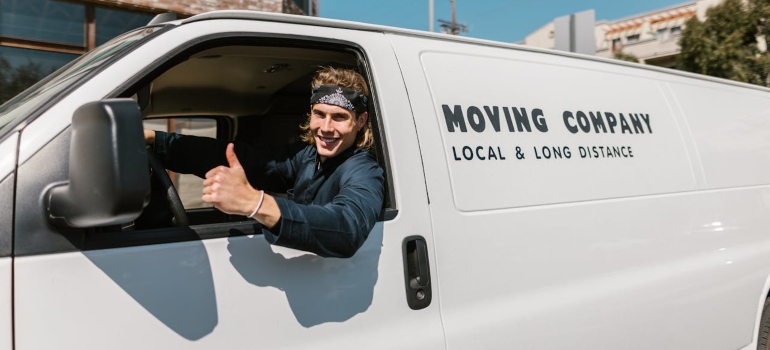 a man sitting in a van and smiling 