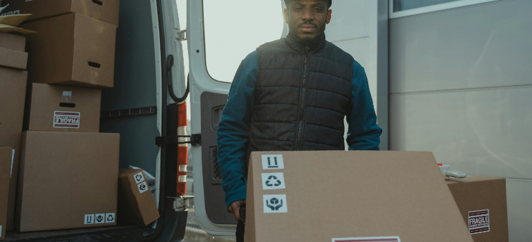 a mover packing a box