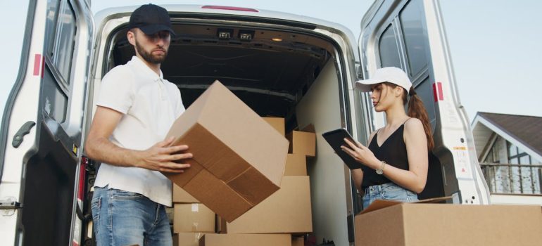 man and woman unpacking boxes