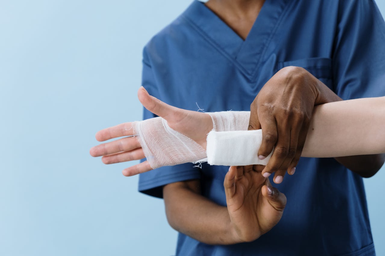 a person getting his hand bandaged