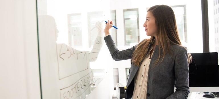 Person writing on a white board