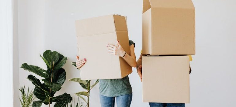 couple carrying boxes