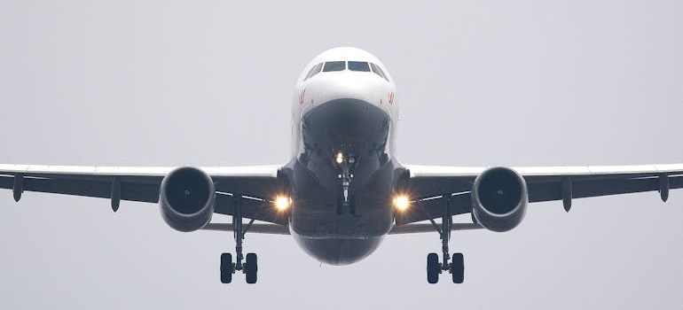 White airplane flying for international logistics company