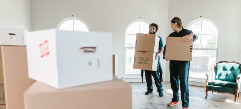 two men holding boxes after learning about how to tackle San Francisco’s parking 