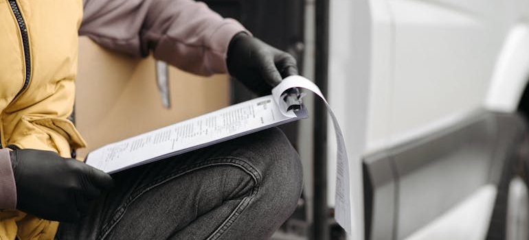 Man checking documentation on his clipboard.