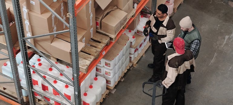 Men receiving training in a warehouse to avoid pitfalls in freight forwarding.