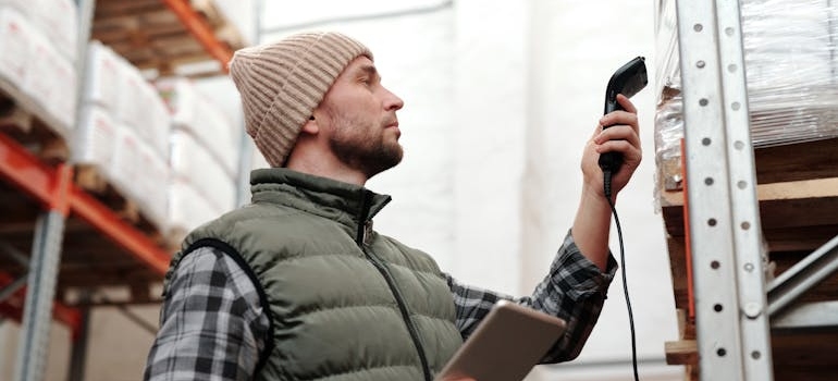 Man checking inventory in a warehouse to avoid pitfalls in freight receiving.