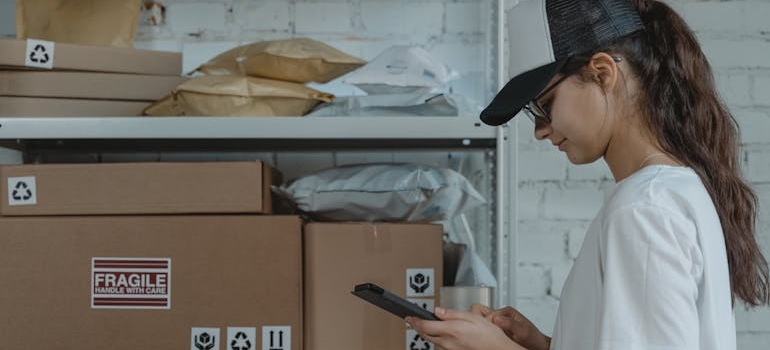 Woman checking inventory on a tablet.