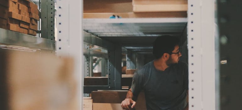 Man looking around a storage unit.