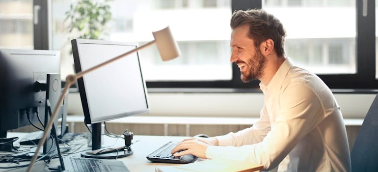 Man looking at his computer as he searches for tips on moving your business to California.