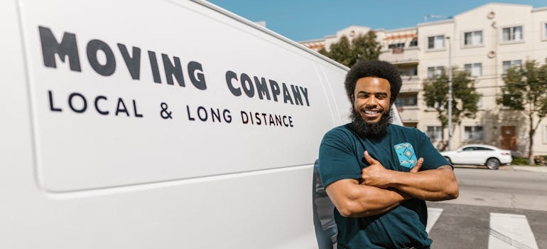 Man standing in front of a moving truck which can help when moving your business to California.