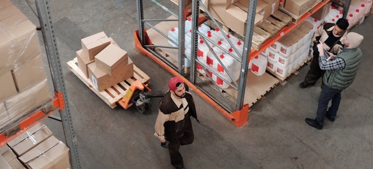 Men walking through a warehouse.