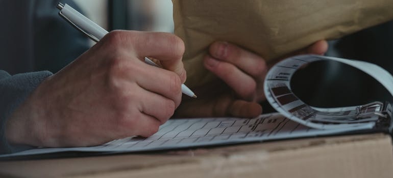 Man writing on a clipboard.