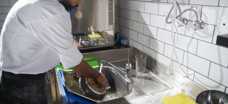 a man cleaning because he know what are the mistakes to avoid when moving restaurant equipment